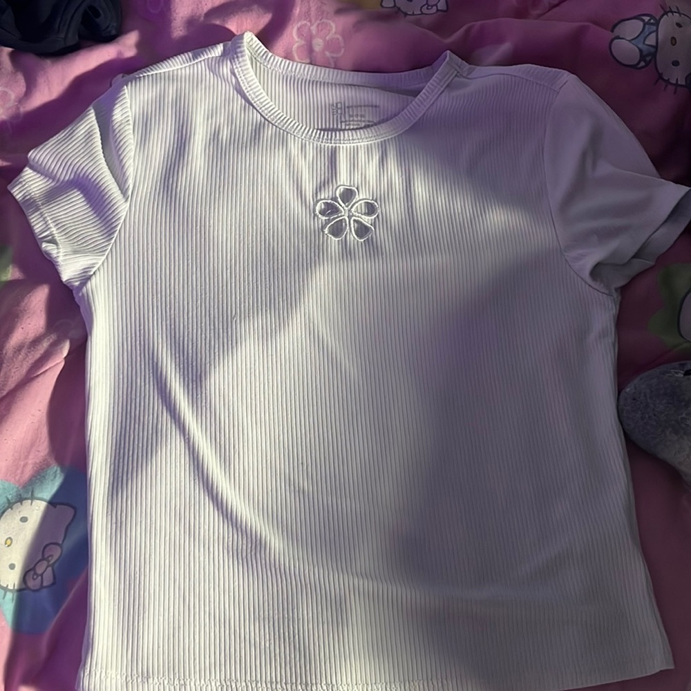 A white tee shirt with a flower right above cleavage. Perfect for summer.